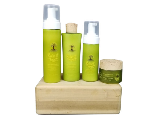 Four skincare products from the robust roots brand arranged on a wooden block.